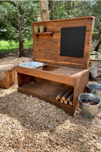 Completed DIY Mud Kitchen after mulch had been added to our outdoor play space