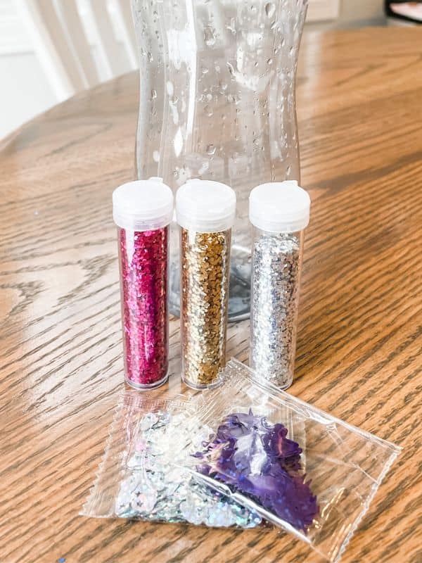 Image of the glitter used in our DIY sensory bottles. The glitter colors include pink, gold, silver, purple unicorns, and silver unicorns. 