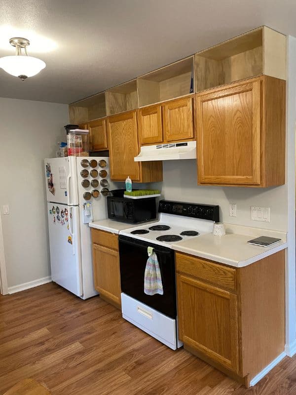 Image of kitchen with the cabinet boxes installed above the existing cabinets. 