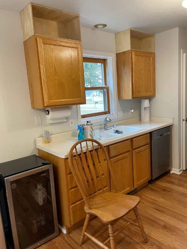 Image of kitchen with the cabinet boxes installed above the existing cabinets. 
