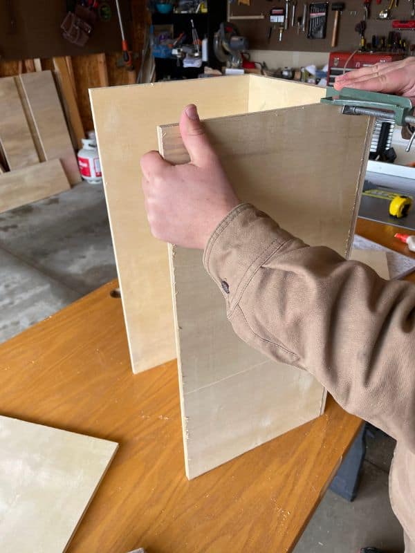 In progress picture of building the cabinet boxes, using a right angle clamp to hold the pieces together. 