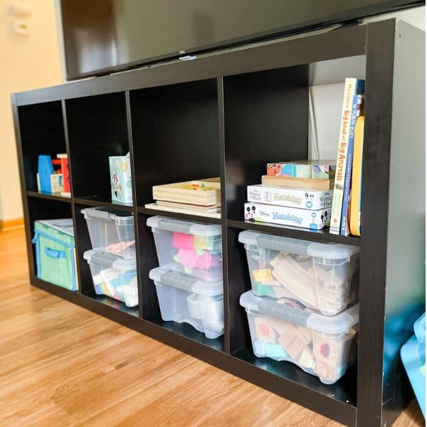 IKEA cube storage organizer being utilized for toy storage in a living room playroom combo area. 