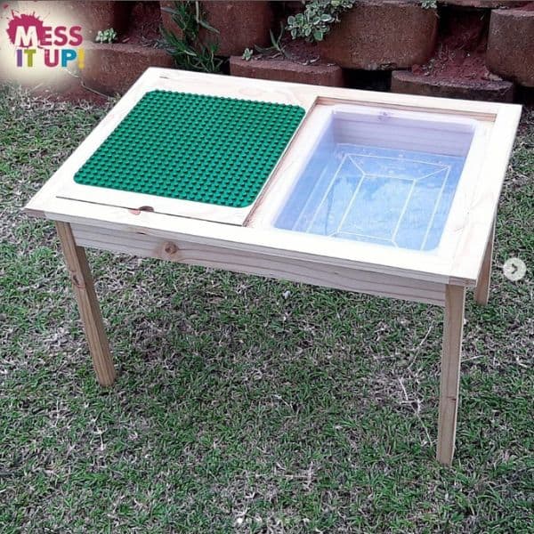 A Lego table with a sensory tray on one side and Lego baseplate for building on the other side. 