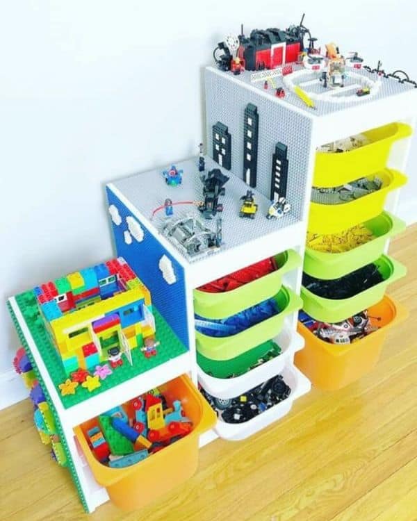 A colorful drawer system with bins sorted by color and a built-in play surface displaying Lego creations.